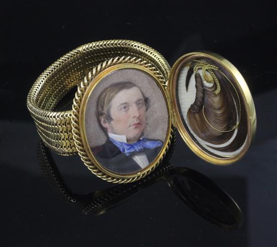 A Victorian gold mesh link mourning bracelet with central oval hinged compartment,